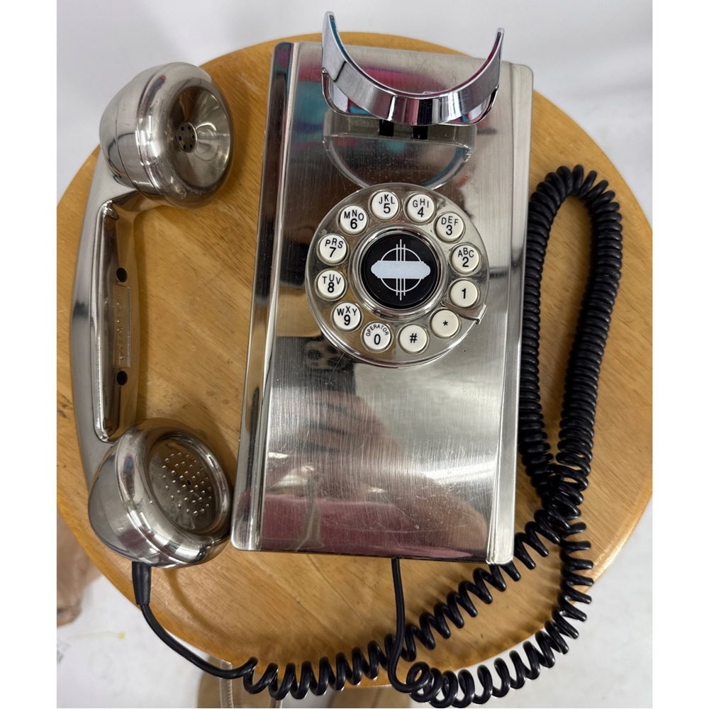 The Crosley Wall Phone Brushed Chrome is a vintage-inspired wall phone